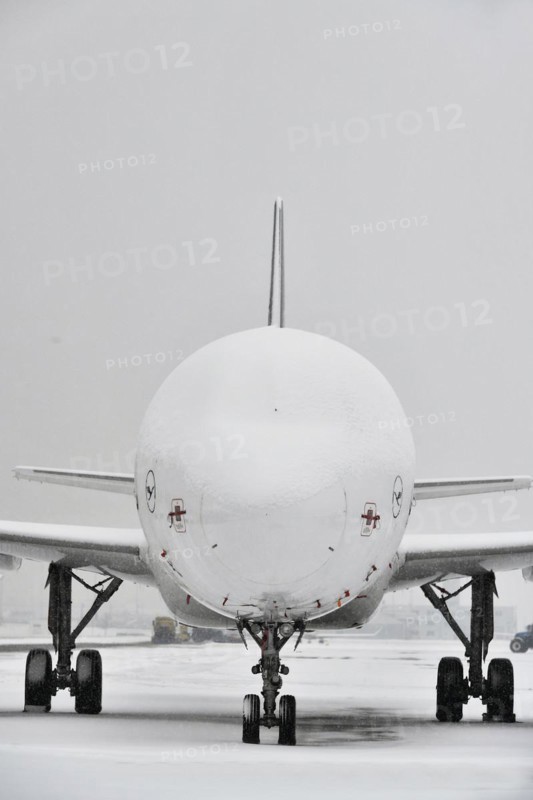 Snow-covered Lufthansa aircraft in winter with snow on apron