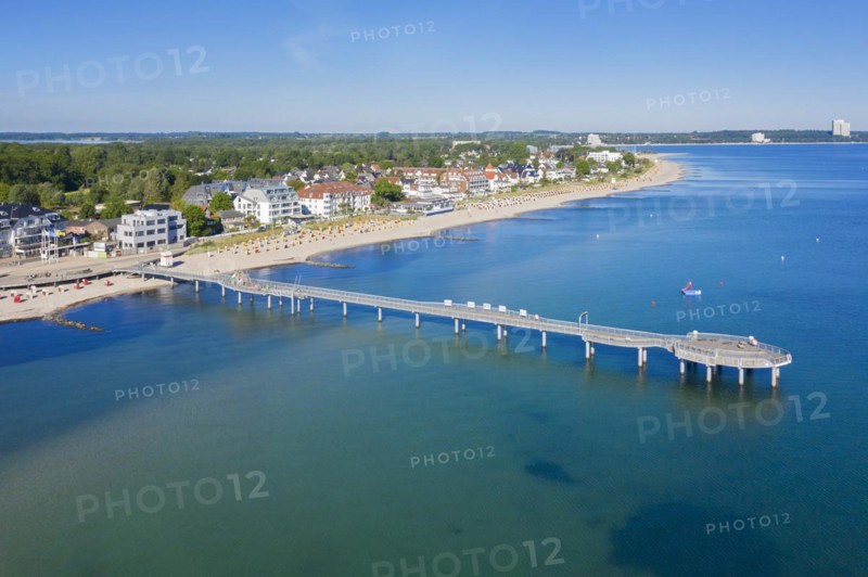 Aerial view over wooden pleasure pier and hotels at seaside resort Niendorf along the Baltic Sea