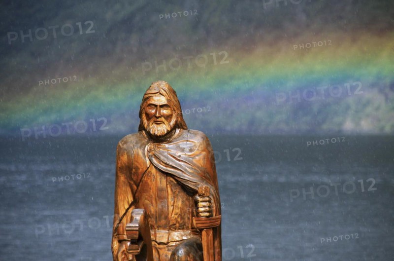 Wooden sculpture of Viking and rainbow over the Naeroyfjord
