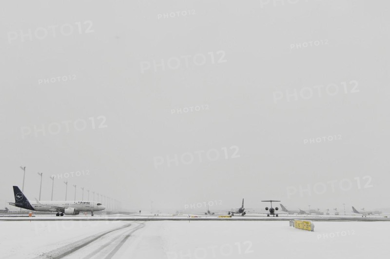 Aircraft in wait for de-icing and take-off clearance in winter snow flurry