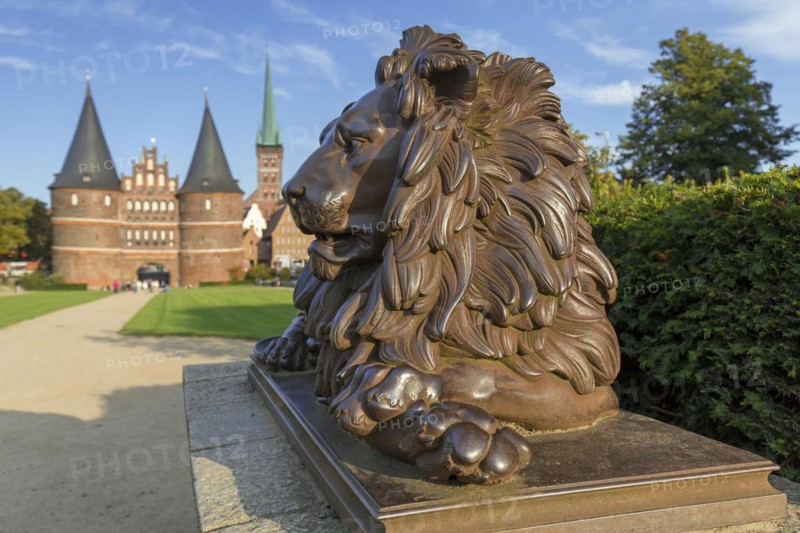 Lion statue in front of the Holstentor Holstein Gate in the Hanseatic town Luebeck