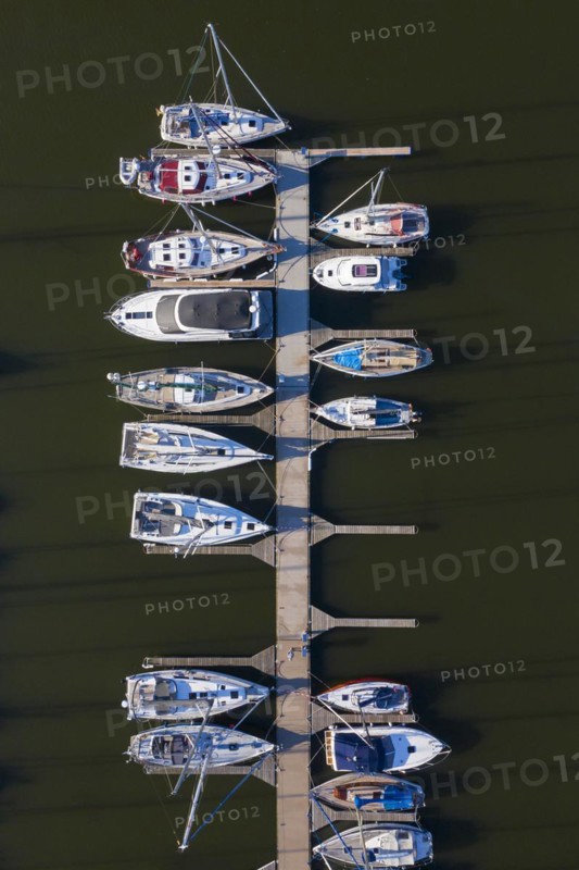 Aerial view over berthing jetty with sailing boats at marina in harbour of the city Stralsund along the Strelasund