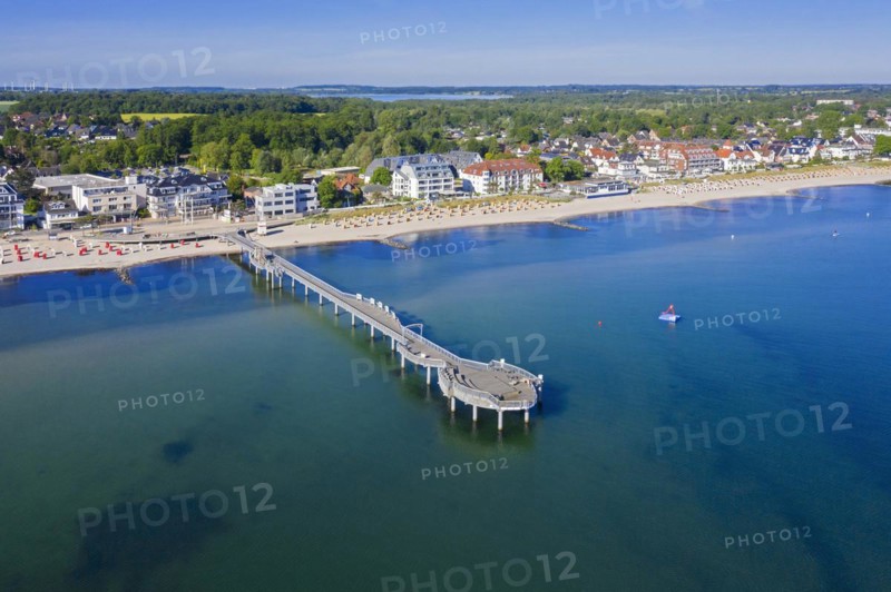 Aerial view over wooden pleasure pier and hotels at seaside resort Niendorf along the Baltic Sea