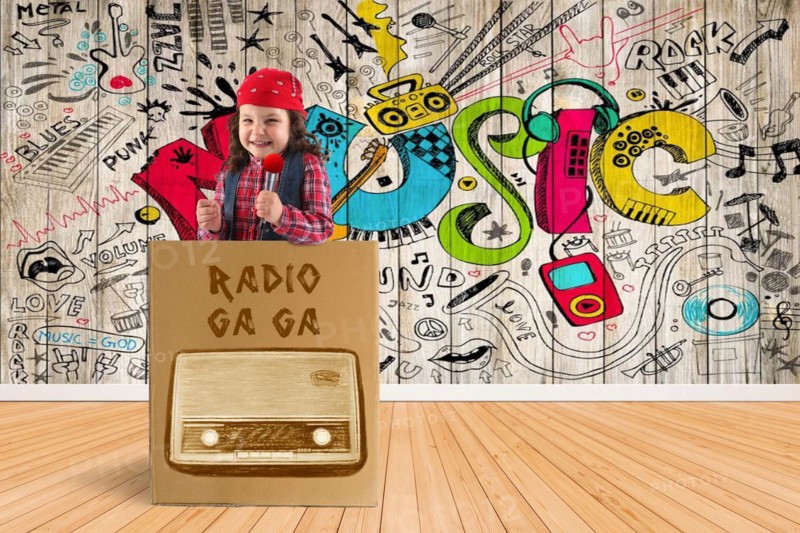 Child as disc jockey stands in a box with a microphone