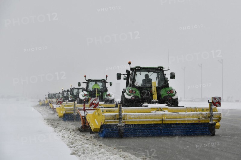 Snow clearing machines and snow removal tractors clearing snow on the apron Cargo