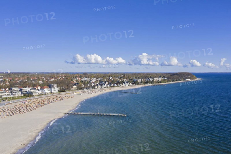 Aerial view over sandy beach with roofed wicker beach chairs at seaside resort Travemuende