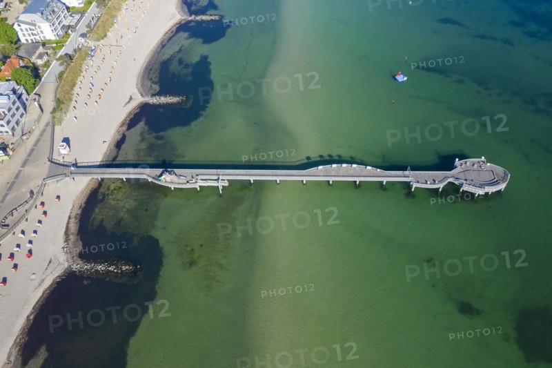 Aerial view over wooden pleasure pier and hotels at seaside resort Niendorf along the Baltic Sea