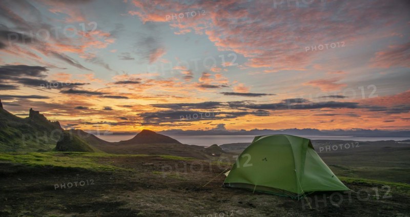 Tent overlooking rocky landscape Quiraing at sunrise