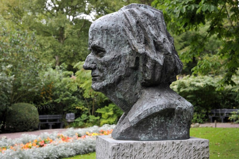Bust of the surrealist painter Paul Delvaux in city park at Veurne