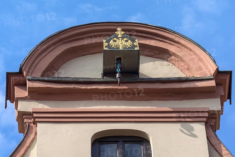 Crane winch decorated with the double-headed eagle on a historic gabled house