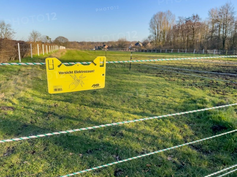 Warning sign on electric fence in wolf area Schermbeck