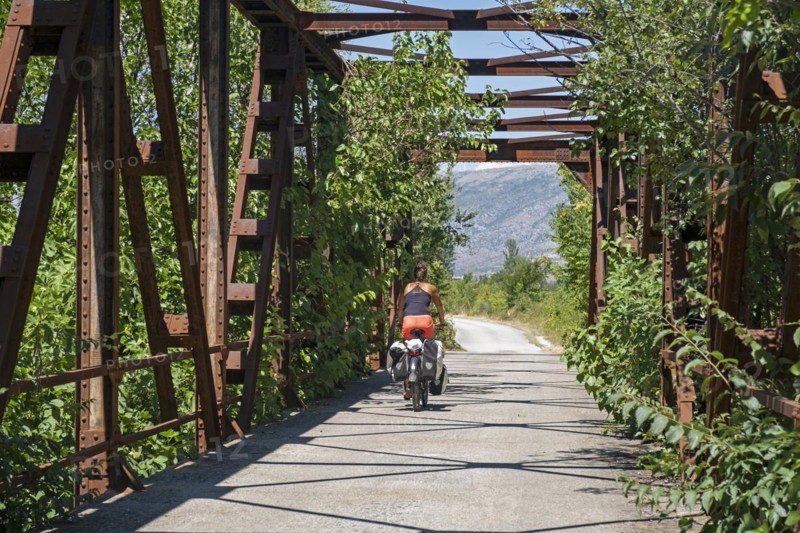 Cycling over old bridge on the Ciro Trail