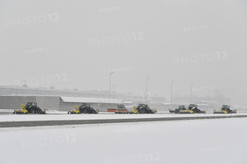 Snow clearing machines and snow removal tractors clearing snow on the apron Cargo