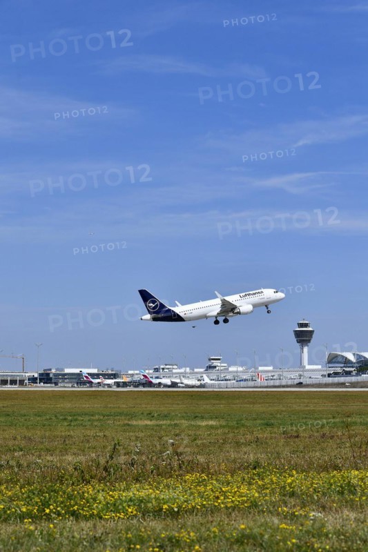 Lufthansa Airbus A320-200 taking off on runway south with tower