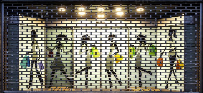 Shop window with roller shutter grille