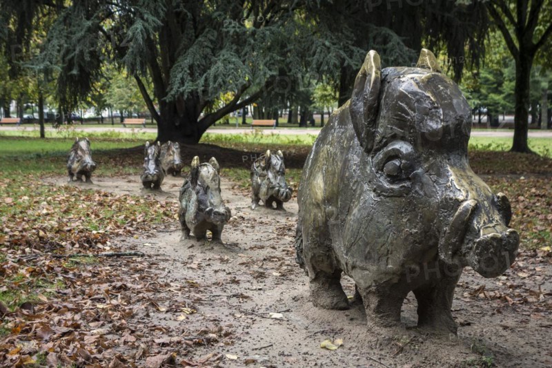 Sculpture group by Alex Garcia of bronze wild boars in the city park Roger Salengro at Nevers