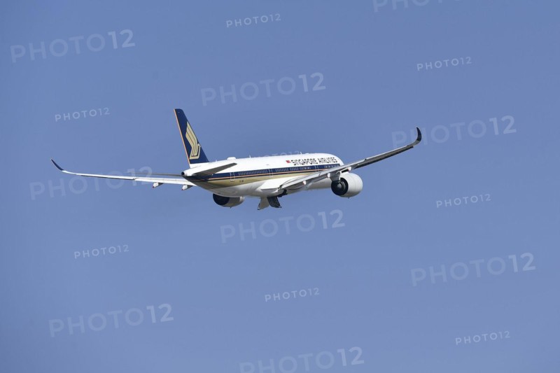 Singapore Airlines Airbus A350-900 taking off on runway south with tower