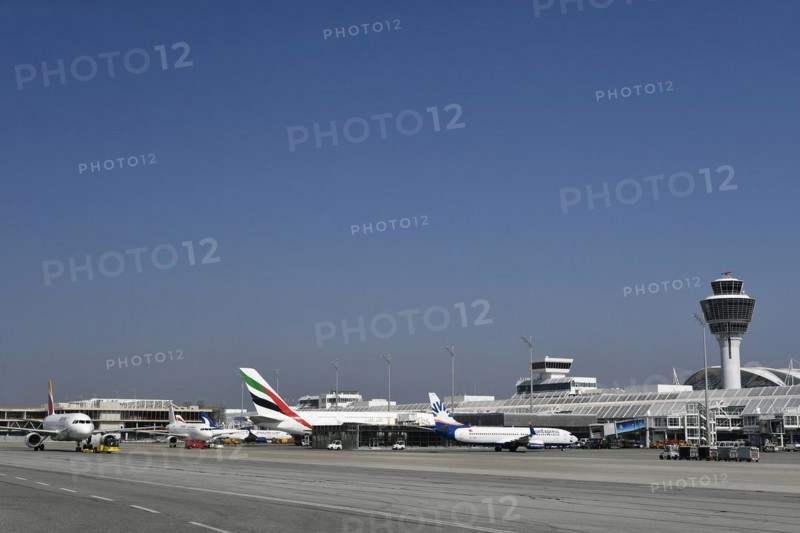Iberia Airbus with Sunexpress Boeing B737 and Emirates Airbus A380-800 in front of Terminal 1 with Tower