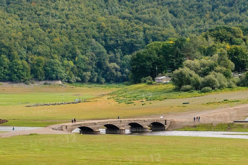 During drought from reservoir Edersee exposed historical bridge over river Eder near village Asel