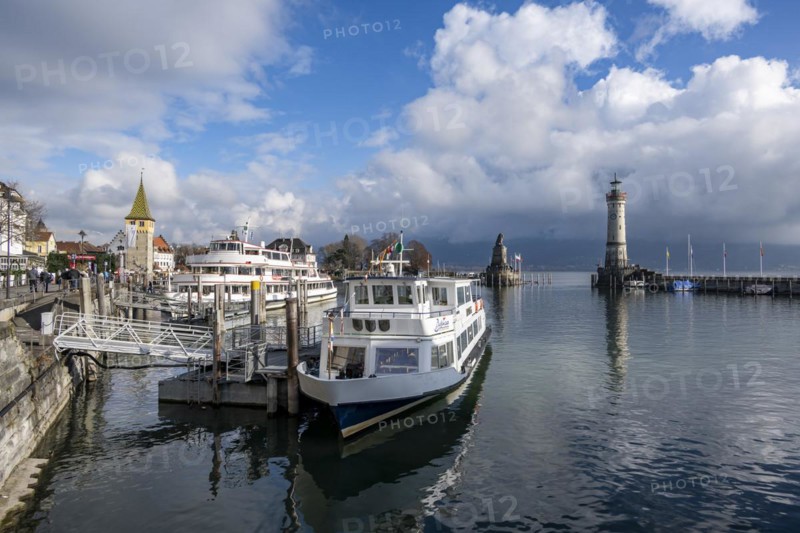 Passenger boats in Lindau harbour, behind harbour entrance with New Lindau Lighthouse and Bavarian Lion, Lindau Island, Lake Constance, Bavaria, Germany, Europe