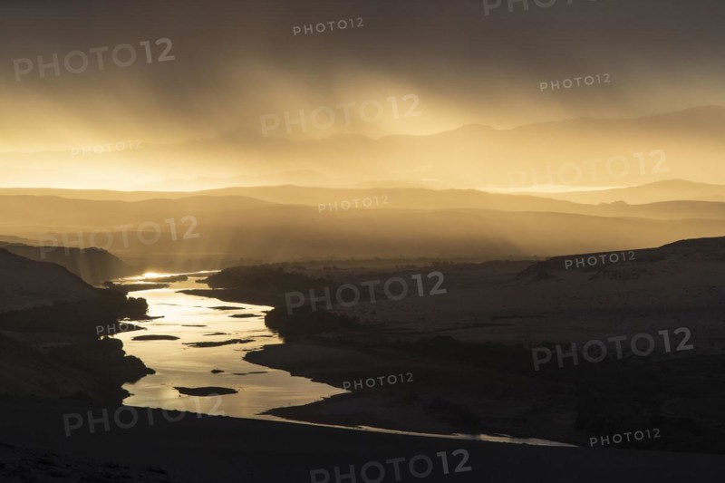 Thunderstorm over the Orange River, also known as the Orange River, on the border between Namibia and South Africa, Oranjemund, Sperrgebiet National Park, also known as Tsau ÇKhaeb National Park, Namibia, Africa
