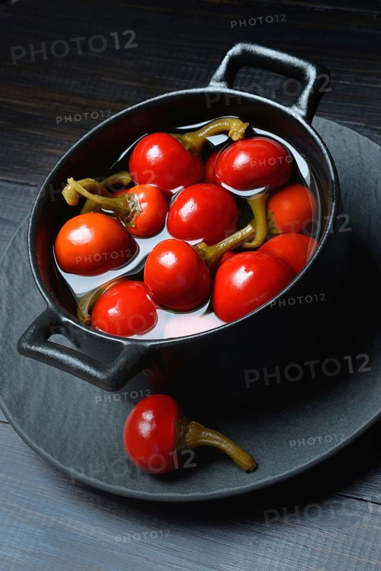 Potted cherry peppers in vinegar, chilli, paprika