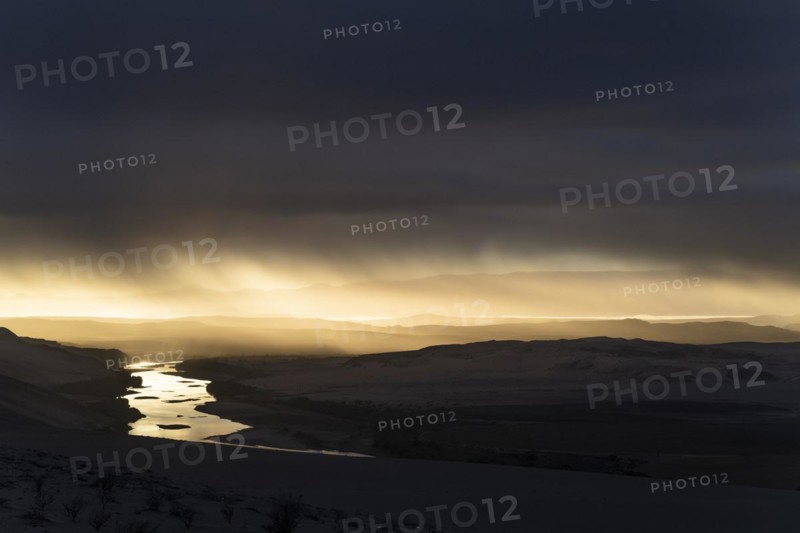 Thunderstorm over the Orange River, also known as the Orange River, on the border between Namibia and South Africa, Oranjemund, Sperrgebiet National Park, also known as Tsau ÇKhaeb National Park, Namibia, Africa