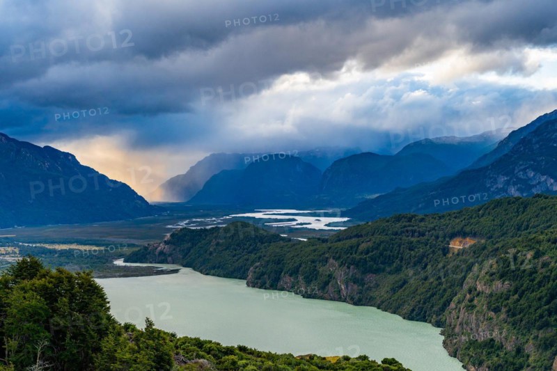 Rays of sunshine break through the rain clouds over the river valley of the Rio Ibanez, Cerro Castillo National Park, Aysen, Patagonia, Chile, South America