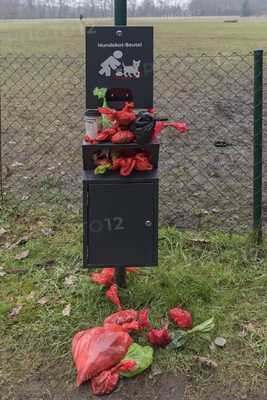 Overcrowded collection point for dog excrement bags in front of a dog playground, Bavaria, Germany, Europe