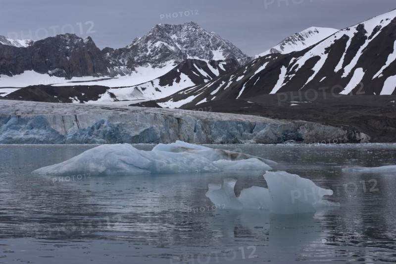 14th of July Glacier, 14e Julebreen, glacier front, in front ice chunks in the fjord, behind glaciated mountains, Krossfjorden, Spitsbergen