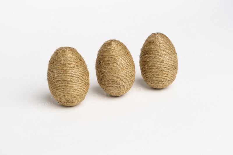 Hand wrapped easter eggs with jute twine, isolated white background. Studio