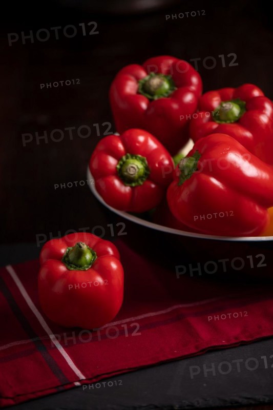 Red peppers in bowl on slate, fitness, cooking, vegetarian, vegan, vitamins, cultivation, healthy, close up, several, kitchen towel