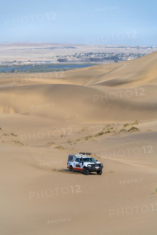 Off-road vehicle in sand dunes above the Orange River, also Oranjemund, Sperrgebiet National Park, also Tsau ÇKhaeb National Park, Namibia, Africa