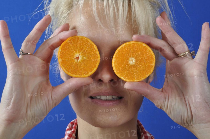 Portrait of womanwith a clementine