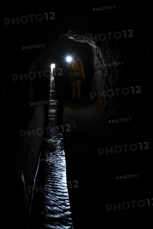 Hiker in a tunnel at Levada do Moinho, Ponta do Sol, Madeira, Portugal, Europe