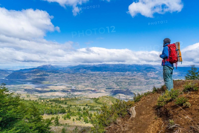 Hikers climbing to the lagoon on Cerro Castillo mountain, with the river valley of the Rio Ibanez in the background, Cerro Castillo National Park, Aysen, Patagonia, Chile, South America
