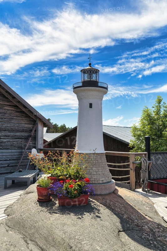 Small lighthouse decorated with flowers, Kaeringsund fishing village, Fasta Aland, Aland Islands, Aland Islands, Finland, Europe
