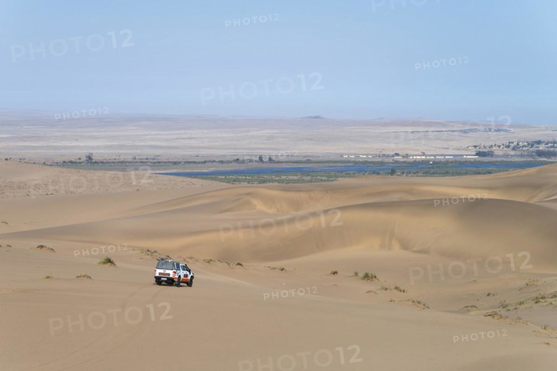 Off-road vehicle in sand dunes above the Orange River, also Oranjemund, Sperrgebiet National Park, also Tsau ÇKhaeb National Park, Namibia, Africa