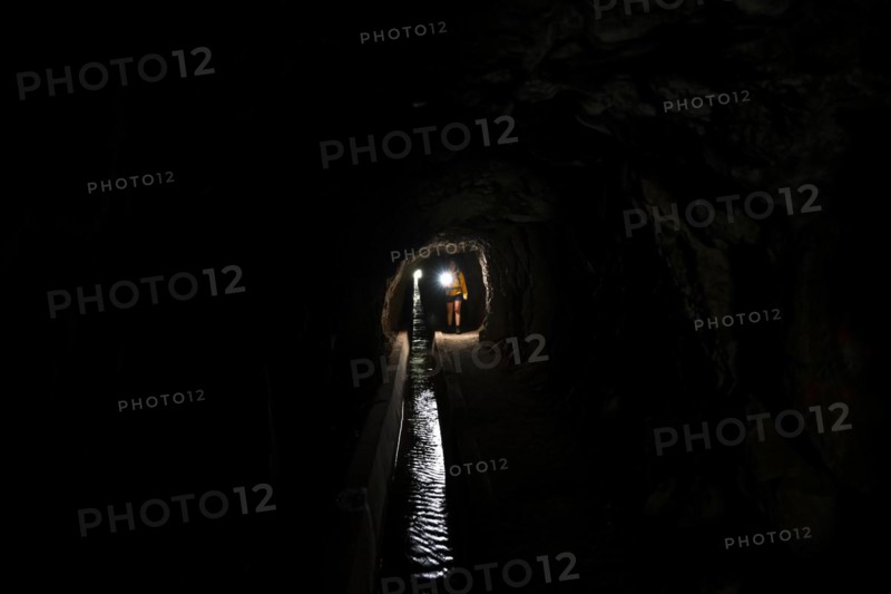 Hiker in a tunnel at Levada do Moinho, Ponta do Sol, Madeira, Portugal, Europe