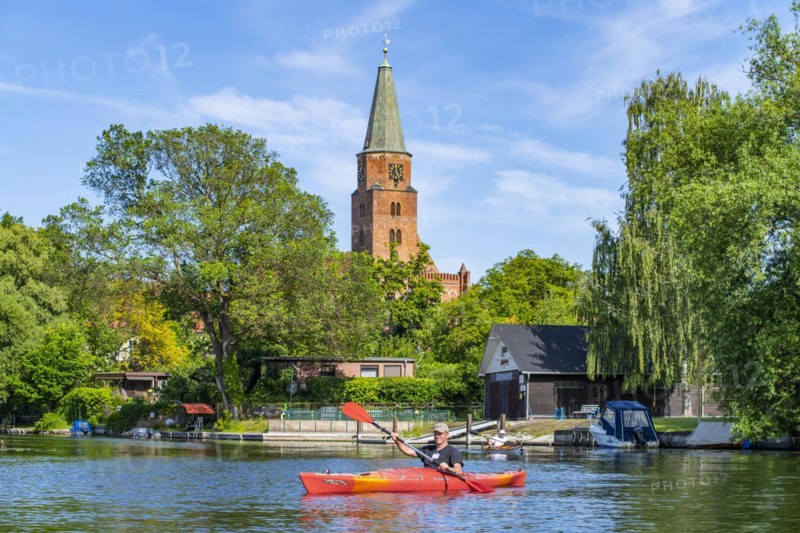 Paddler in a kayak in front of the Cathedral of St. Peter and Paul, Cathedral Island, Brandenburg an der Havel, Brandenburg, Germany, Europe