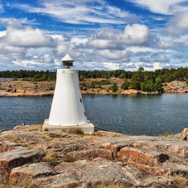 Coastline with lighthouse on rocks, sunny weather, Kaeringsund, Fasta Aland, Aland Islands, Aland Islands, Finland, Europe