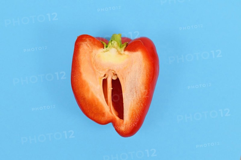 Open red bell pepper on blue background
