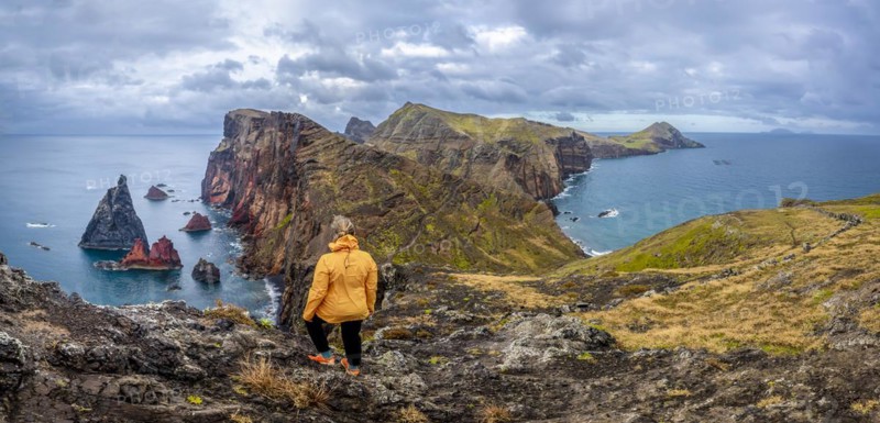 Hiker, coastal landscape, cliffs and sea, Miradouro da Ponta do Rosto, rugged coastline with rock formations, Cape Ponta de Sao Lourenco, Madeira, Portugal, Europe