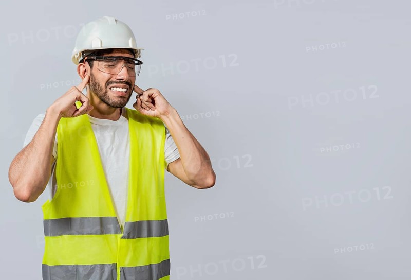 Engineer with ear pain isolated, Young engineer covering his ears isolated, Builder man with ear pain, Concept of engineer covering his ears with pain expression