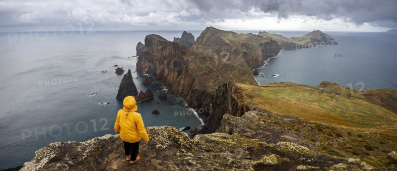 Hiker, coastal landscape, cliffs and sea, Miradouro da Ponta do Rosto, rugged coastline with rock formations, Cape Ponta de Sao Lourenco, Madeira, Portugal, Europe