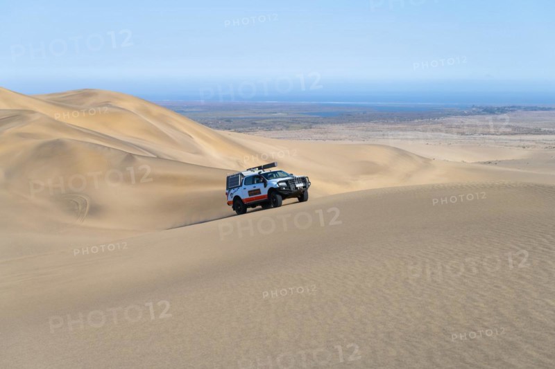 Off-road vehicle in sand dunes above the Orange River, also Oranjemund, Sperrgebiet National Park, also Tsau ÇKhaeb National Park, Namibia, Africa