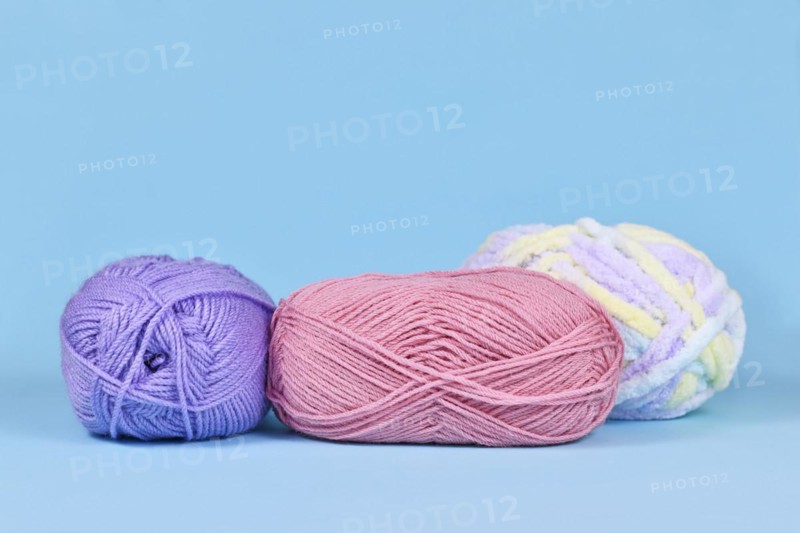 Balls of wool on pastel blue background