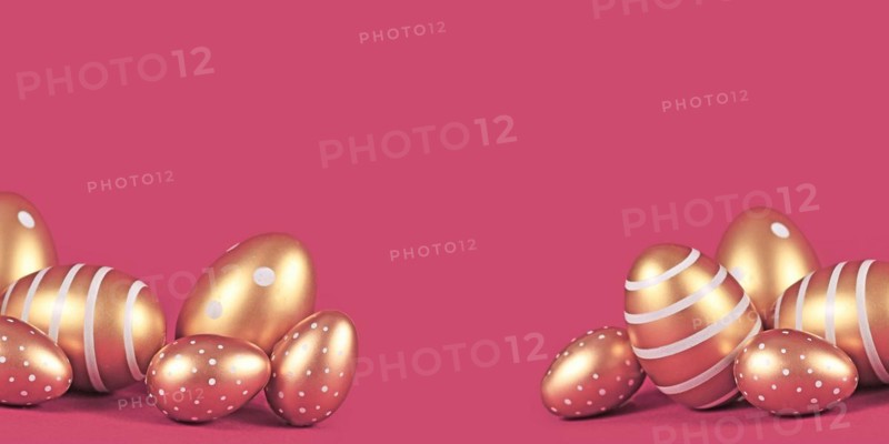 Banner with golden Easter eggs with simple stripe and dot pattern on pink background with copy space