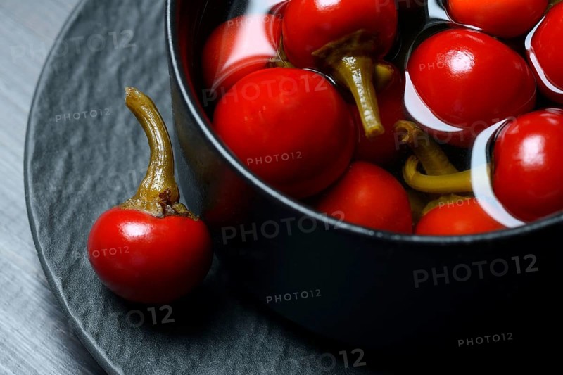 Potted cherry peppers in vinegar, chilli, paprika