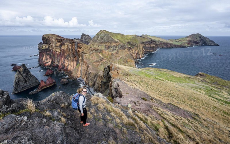 Hiker, coastal landscape, cliffs and sea, Miradouro da Ponta do Rosto, rugged coastline with rock formations, Cape Ponta de Sao Lourenco, Madeira, Portugal, Europe